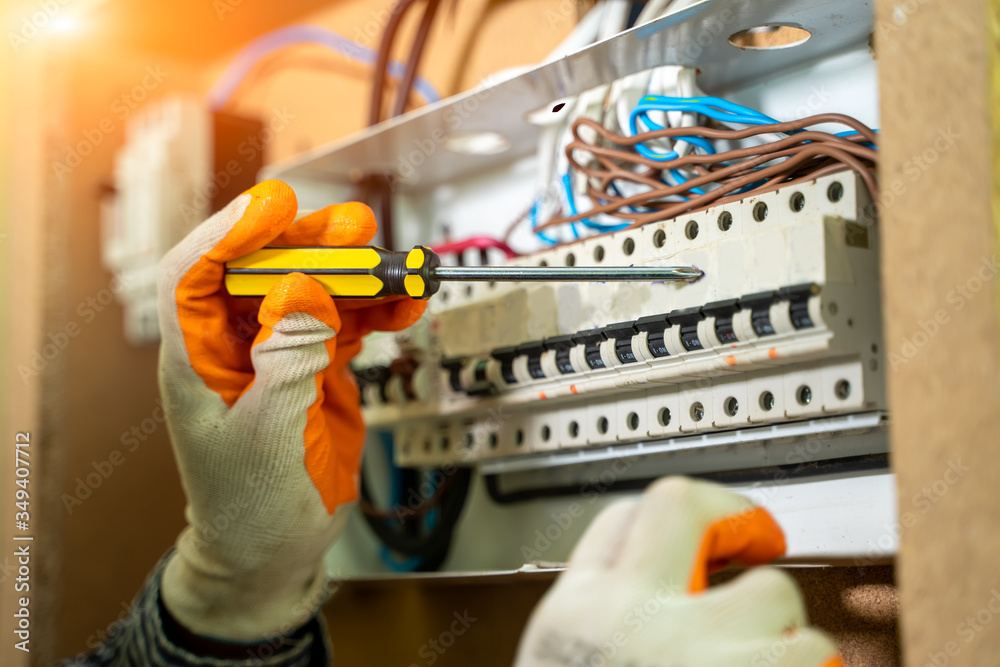 Aufkleber Electrician Installing Socket In New House,Electrician working safely on switches and sockets of a residential electrical system.