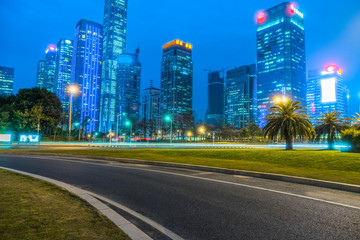 Empty urban road and shenzhen skyline at night