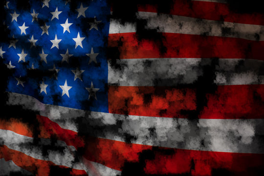 Disturbing photo with an American flag. American flag in the smoke. The US flag is partially obscured by black clouds.
