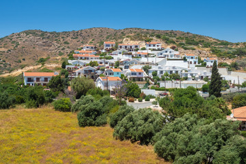 Fototapeta premium Cyprus. The village of Pissouri on the background of the hill. Resort place in Cyprus. Village of white houses in Cyprus. Vacation in the Mediterranean. Seaside resort.
