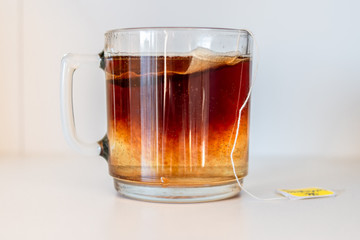 Cup with black tea in sachet