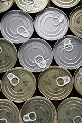 various tuna cans in gold and silver color from a top view