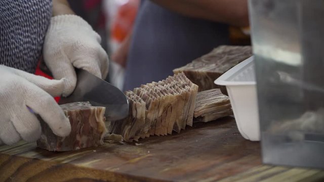 Busan, South Korea - October 8, 2019 
 : Korean traditional food, Pork and Rice Soup, Dwaeji-gukbap. It's very popular in Busan, South Korea. the pork is now sliced and ready to be put into the soup.