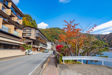 Japan. Embankment by the lake Kawaguchiko. Resorts by the lake. Kawaguchiko lake on the background of blue sky. Autumnal nature of Japan. Kawaguchiko lake on a sunny day. Fujikawaguchiko Tourism