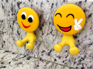 Happy fun yellow smiling emoji couple with peace sign dental toys