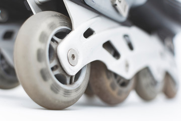 closeup to the wheels of used roller skates.