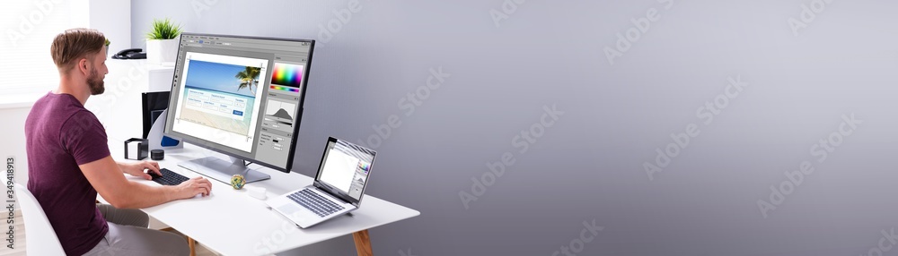 Poster Designer Editing Photo On Computer
