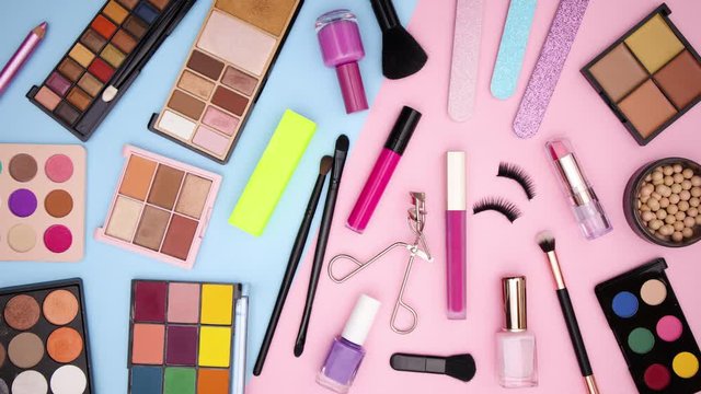 Make up palettes and products appear from right to left on pastel background - Stop motion 