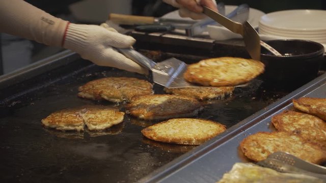 Bindae-tteok in Gukje International Market Busan city. Bindaetteok, fried buchimgae, savory pancake with ground mung beans, vegetables, meat. Korean vendors selling food in street, South Korea