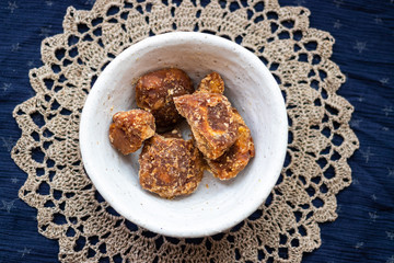 Jaggery or goor - asian brown unrefined cane or palm sugar made in India.