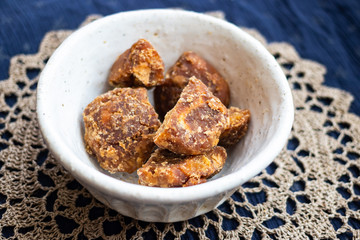 Jaggery or goor - asian brown unrefined cane or palm sugar made in India.
