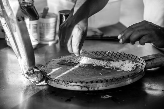 Isla Mujeres, Mexico, Traditional Yucatan Marquesita is a crepe or waffle roll, which is pressed with a heavy iron grill, over an open fire, then filled with a grated cheese and chocolate 