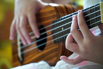Girls practice playing the classic ukulele,close up,Stay at home
