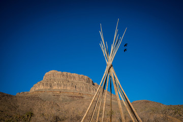 view of the american west with a saddle and a teepee © flariv