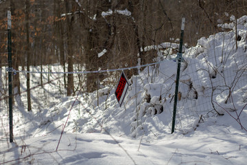 A private property sign in snow covered forest