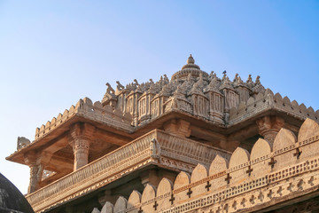 Obraz premium Exterior facades roofs of Jain Ranakpur Temple stone carving, Udaipur, Rajasthan, India , Udaipur, Rajasthan, India