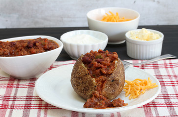 Chili stuffed baked potato set for dinner.
