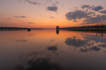 charming landscape on the river at sunset and night time
