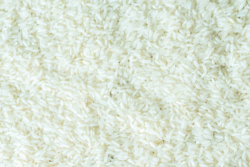 Grains of white ground rice as a background. The view from the top.