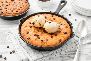 Giant skillet cookie with chocolate chips served with ice cream.