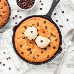 Giant skillet cookie with chocolate chips served with ice cream.