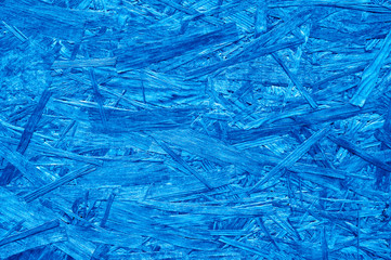 plywood. background texture of aged sheet of plywood with fragments of compressed sawdust. toned classic blue color trend 2020 year
