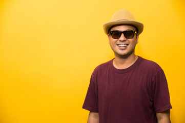 Smiling Happiness young asian man on yellow background