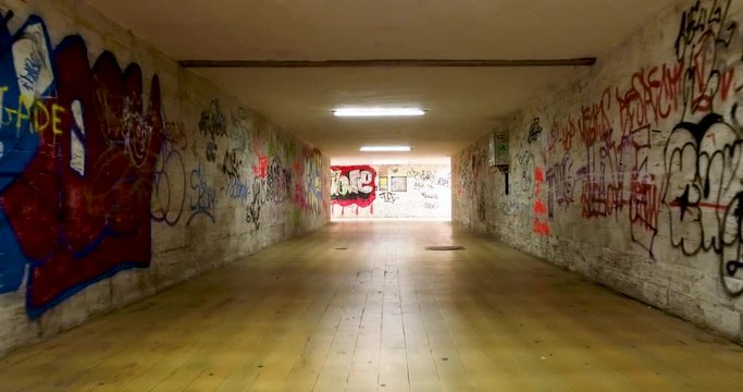 Underground pedestrian underpass with graffiti 