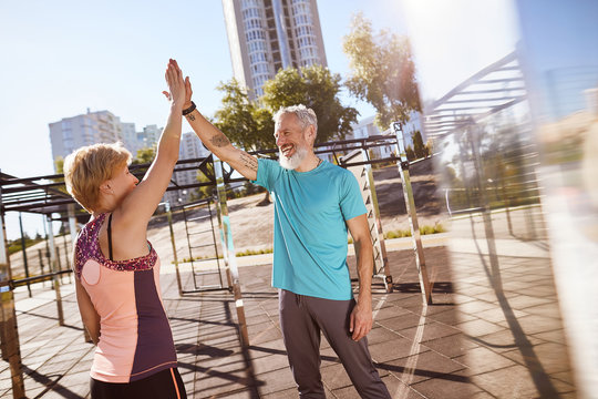 Great Morning Workout. Happy Mature Family Couple Giving High Five After Successful Training Outdoors, Aged Couple Doing Sport Together