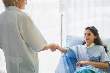 Female doctor meet the patient and handshake