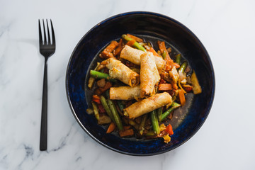 plant-based food, vegan stir fry veggies with spring rolls