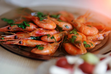 Delicious prawns with coriander in a plate on the table. Fresh seafood dish close-up