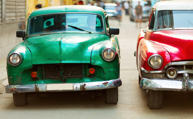 HAVANA - FEBRUARY 25: Classic car and antique buildings on February 25, 2015 in Havana. These vintage cars are an iconic sight of the island