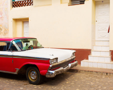 TRINIDAD - FEBRUARY 24: Streets of Trinidad with classic old car on February 24, 2015 in Trinidad. Old American cars are iconic sight of Cuba street.