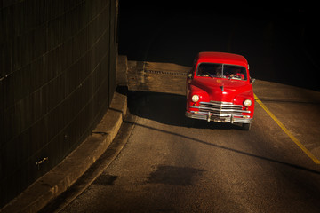 HAVANA - FEBRUARY 26: Classic car and antique buildings on February 26, 2015 in Havana. These vintage cars are an iconic sight of the island
