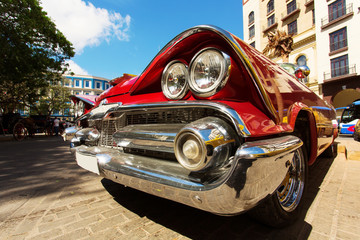 HAVANA - FEBRUARY 26: Classic car and antique buildings on February 26, 2015 in Havana. These vintage cars are an iconic sight of the island