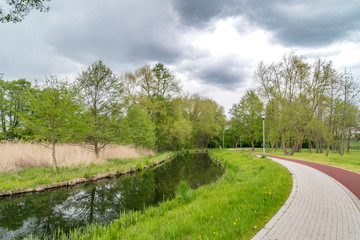 Fototapeta na wymiar Radunia canal and walking and cycling path in Pruszcz Gdanski.