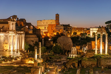 Fototapeta na wymiar View over the ruins of the Roman Forum in Rome at dawn with the Colosseum in the back