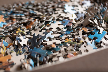 A view of jigsaw puzzle pieces in a box.