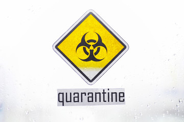 Obraz premium Quarantine. Quarantine warning sign on a glass door in a hospital isolator. Isolation of patients with the virus in special laboratories. Virus.