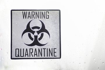 Quarantine. Quarantine warning sign on a glass door in a hospital isolator. Isolation of patients with the virus in special laboratories. Virus.