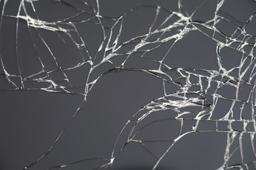 Crack on the glass. Broken screen. Broken phone. Cracked glass background. White cracks in the glass.
