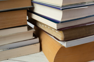 A view of several book stacks, featuring the blank page corners of each book.