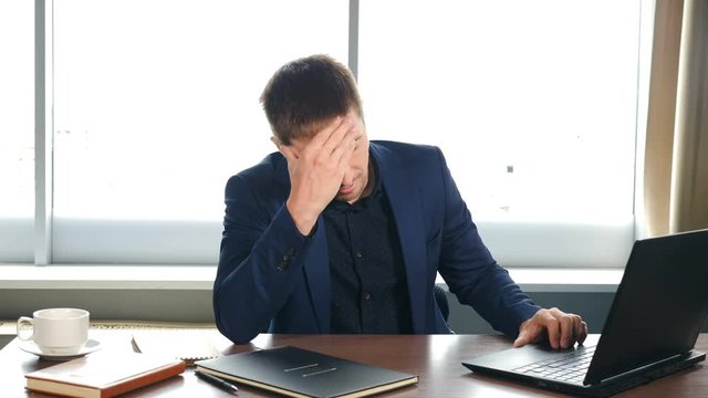 Depressed desperate man feeling worried about financial problem. Stressed businessman looking frustrated thinking of money debt, budget loss, bankruptcy sitting at home or in office. Worried business