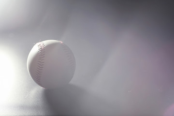 American traditional sports game. Baseball. Concept. Baseball ball and bats on a black table.
