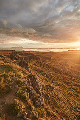Iceland landscape at sunset. Amazing view of mountains and lake with dramatic cloudy sky. Wonderful wild nature