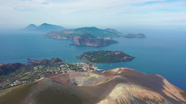 Aerial view 4K video from flying drone of Panoramic view from mountain roadsthe volcano of Vulcano Island in a summer day. The islands of Lipari and Salina Aeolian Islands, Sicily, Italy. (series)