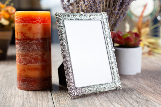 A view of a blank picture frame, in a still life setting.