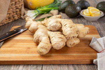 Fototapeta na wymiar A view of a cluster of ginger on a cutting board.