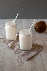 Coconut milk in glass jars, side view.